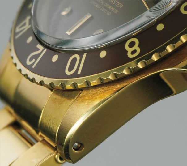 An early, rare and attractive yellow gold dual time wristwatch with date, bracelet with punched papers and box